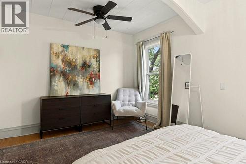 Room featuring light-toned walls, wood-finish flooring, and a ceiling fan - 148 Dundurn Street N, Hamilton, ON 