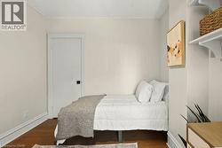 Hardwood-finish flooring complements light-toned walls and white trim - 