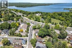 Aerial perspective highlighting the expansive body of water, bordered by extensive green spaces and mature trees - 