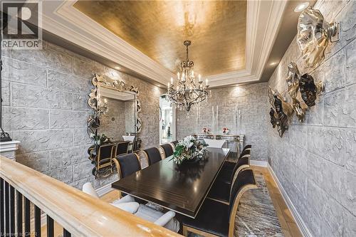 Formal dining space featuring textured block-patterned walls, a gilded ceiling, and crown molding - 712 Highvalley Road, Ancaster, ON 