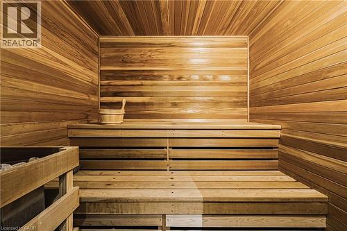 Custom-built sauna featuring horizontal wood paneling, multi-level slatted benches, and an integrated heater - 712 Highvalley Road, Ancaster, ON 