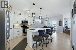 Beautiful kitchen with quartz counters and gas stove - 