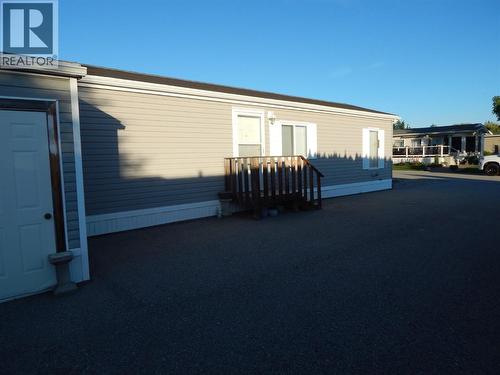 The West side of Unit #55  Evening shade provided by Cedar shrubs on Neighbouring lot. - 724 Devon Street Unit# Unit  #55, Creston, BC 