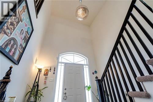 Foyer featuring a high vaulted ceiling, arched transom window, and a contemporary chandelier - 928 Dunblane Court, Kitchener, ON - Indoor Photo Showing Other Room