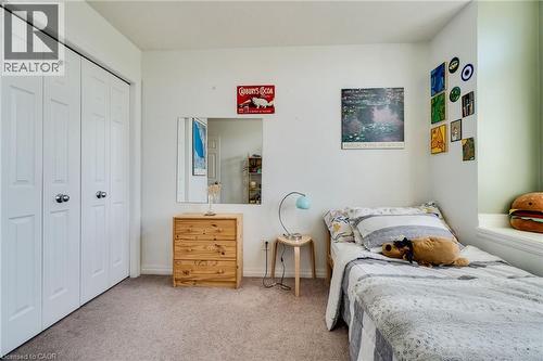 Carpeted interior space featuring white bi-fold closet doors, a built-in window seat, and light-colored walls - 928 Dunblane Court, Kitchener, ON - Indoor Photo Showing Bedroom