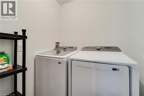 Dedicated laundry space featuring white walls and a functional shelving unit - 928 Dunblane Court, Kitchener, ON - Indoor Photo Showing Laundry Room