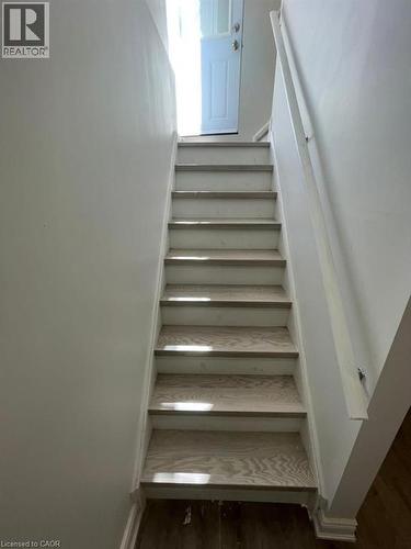 Staircase featuring wood-finish treads and white risers - 928 Dunblane Court, Kitchener, ON - Indoor Photo Showing Other Room