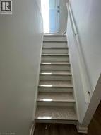 Staircase featuring wood-finish treads and white risers - 