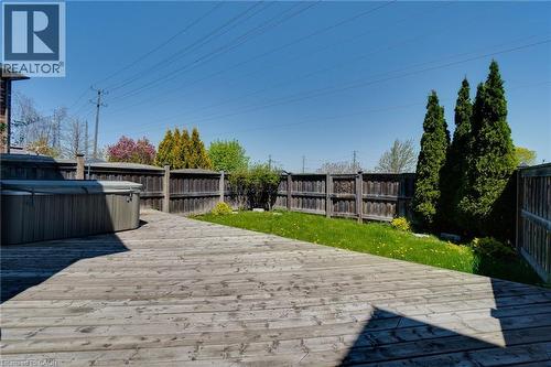 Spacious wood deck with perimeter fencing and a grass lawn area - 928 Dunblane Court, Kitchener, ON - Outdoor