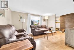 Living area featuring light wood-finish flooring and neutral wall tones - 