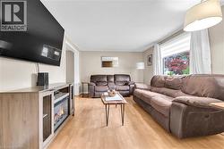 Open-concept living space with light wood-finish flooring - 