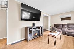 Living area featuring wood-finish flooring and neutral wall tones - 