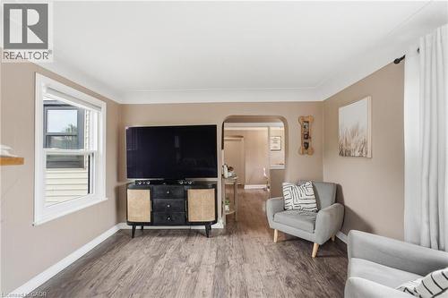 Living area featuring wood-finish flooring, neutral wall paint, and white trim - 481 Upper Gage Avenue, Hamilton, ON - Indoor Photo Showing Living Room