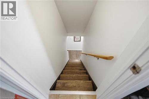 Basement Stairwell featuring wood-finish treads, a light wood handrail, and white painted walls - 481 Upper Gage Avenue, Hamilton, ON - Indoor Photo Showing Other Room