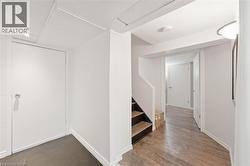 Basement landing opening to kitchen on one side and living room on the other - 
