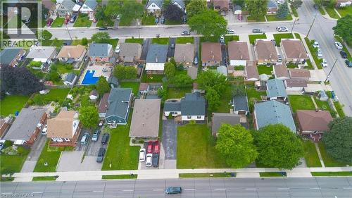 Aerial perspective highlighting a residential neighborhood with diverse architectural styles, mature trees, and paved roadways - 481 Upper Gage Avenue, Hamilton, ON -  With View