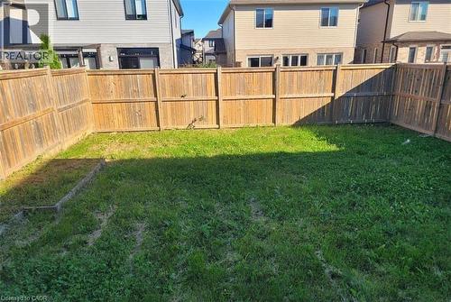 Expansive grassy yard area defined by wood privacy fencing - 766 Freeport Street, London, ON 