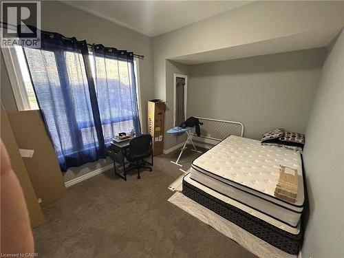 Carpeted room with a large window featuring white trim and a curtain rod - 766 Freeport Street, London, ON 