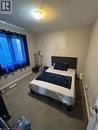 Carpeted room featuring a window with a white frame and light-colored walls - 