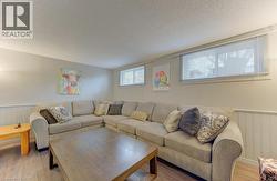 Wood-finish flooring with light gray walls and white wainscoting - 