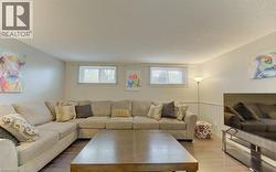 Spacious room featuring wood-finish flooring, light gray walls, and white trim - 