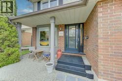 Brick exterior featuring a covered porch with a gravel patio area - 
