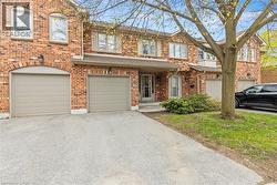 Brick exterior featuring multiple windows and a covered front entry - 