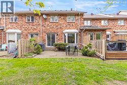 Brick exterior featuring multiple windows and a bay window - 
