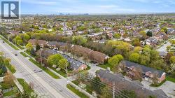 Aerial perspective showcasing a residential area with individual homes and multi-unit townhome structures - 