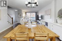 Open-concept living area with dark wood-finish flooring - 