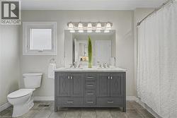 Dual vanity with a white countertop and undermount sinks - 