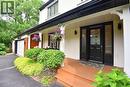 Two-story exterior featuring a black front door with decorative glass inserts and two side lites - 4299 Lakeshore Road, Burlington, ON  - Outdoor With Deck Patio Veranda 