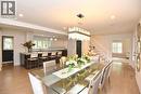 Bright interior featuring light wood-finish flooring, recessed lighting, and a contemporary chandelier - 4299 Lakeshore Road, Burlington, ON  - Indoor Photo Showing Dining Room 