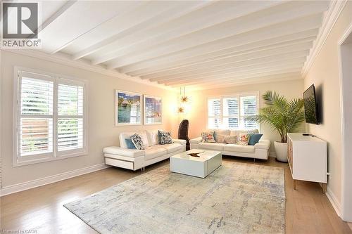 Living space featuring a coffered ceiling, wood-finish flooring, and crown molding - 4299 Lakeshore Road, Burlington, ON - Indoor Photo Showing Living Room