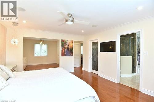 Hardwood flooring extends throughout this space, featuring crown molding, recessed lighting, and a ceiling fan - 4299 Lakeshore Road, Burlington, ON - Indoor Photo Showing Bedroom