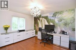 Wood-finish flooring complemented by a white wall with an accent mural - 