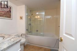 Bathroom with a built-in tub and glass shower enclosure - 