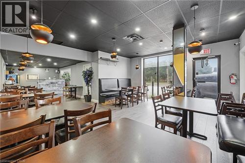 Spacious dining area featuring recessed lighting, a drop ceiling, light wood-finish flooring, and large storefront windows - 239 York Boulevard, Hamilton, ON 