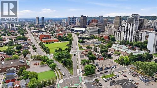 Aerial perspective of a vibrant urban landscape featuring diverse architectural styles, expansive green spaces, and a prominent downtown skyline - 239 York Boulevard, Hamilton, ON 