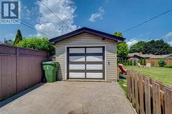 Detached garage with horizontal siding and a contemporary panel garage door - 