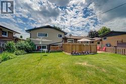 Spacious green lawn with established perimeter landscaping and partial privacy fencing - 