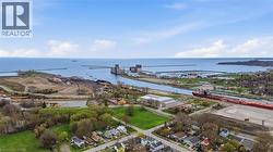 Expansive waterfront setting featuring a large body of water, a canal system, and industrial structures - 