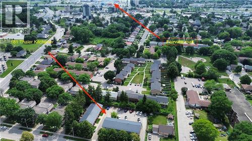 Aerial perspective of a developed neighborhood featuring residential buildings, mature trees, and paved roadways - 181 Thaler Avenue, Kitchener, ON 