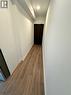 Hallway featuring wood-finish flooring, white baseboards, and a recessed ceiling light - 2782 Barton Street E, Hamilton, ON 