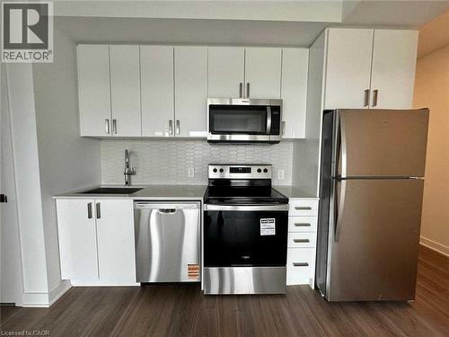 Contemporary kitchen featuring white cabinetry and stainless steel appliances - 2782 Barton Street E, Hamilton, ON 