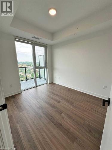 Bright room featuring a full-height glass door opening to a private balcony - 2782 Barton Street E, Hamilton, ON 