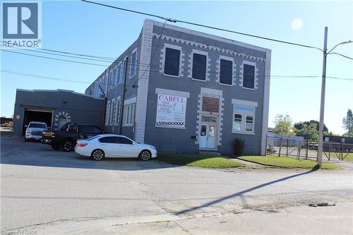 Two-story commercial building featuring a gray painted facade with white trim - 720 Cabell Street, London, ON 