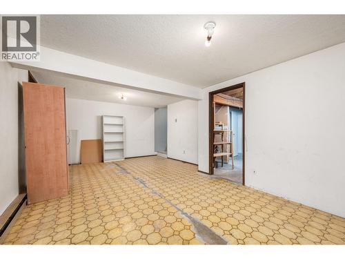Flooring is now replaced with laminate - 5008 Heritage Drive, Vernon, BC - Indoor Photo Showing Other Room