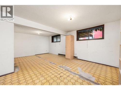 Flooring is now replaced with laminate - 5008 Heritage Drive, Vernon, BC - Indoor Photo Showing Other Room