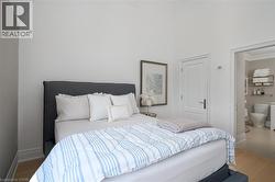 Vaulted ceiling room featuring light wood-finish flooring - 